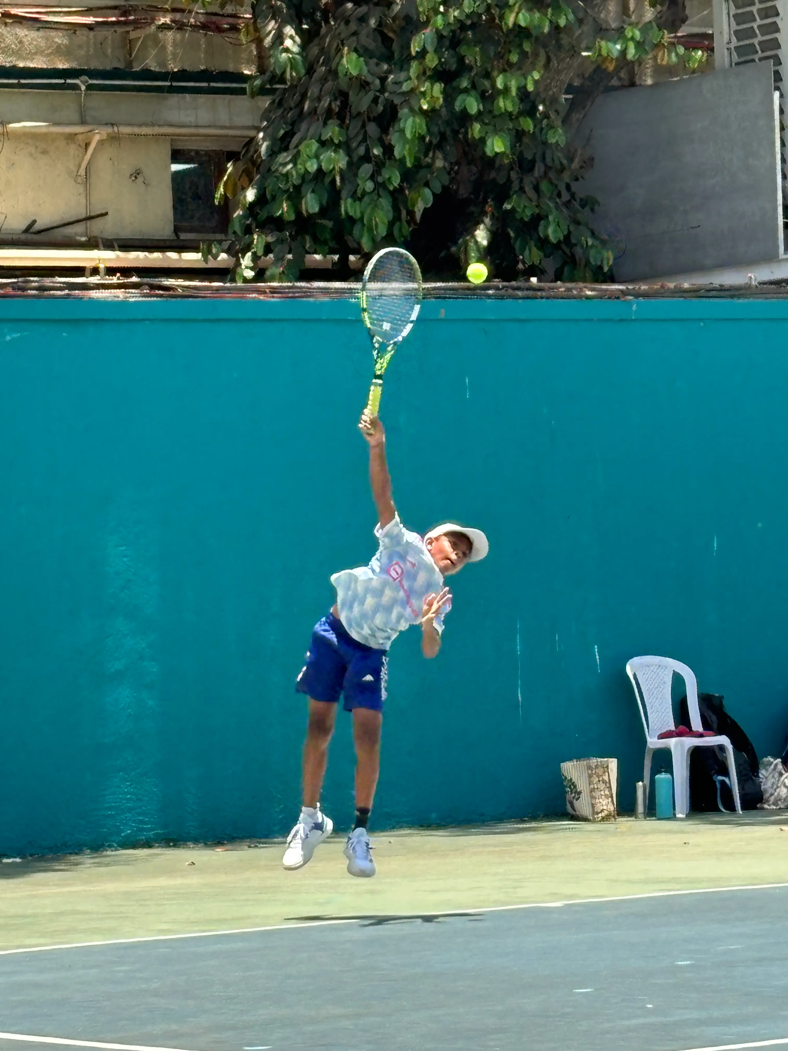 Sparsh at the Bombay Gymkhana tournament hitting a high serve